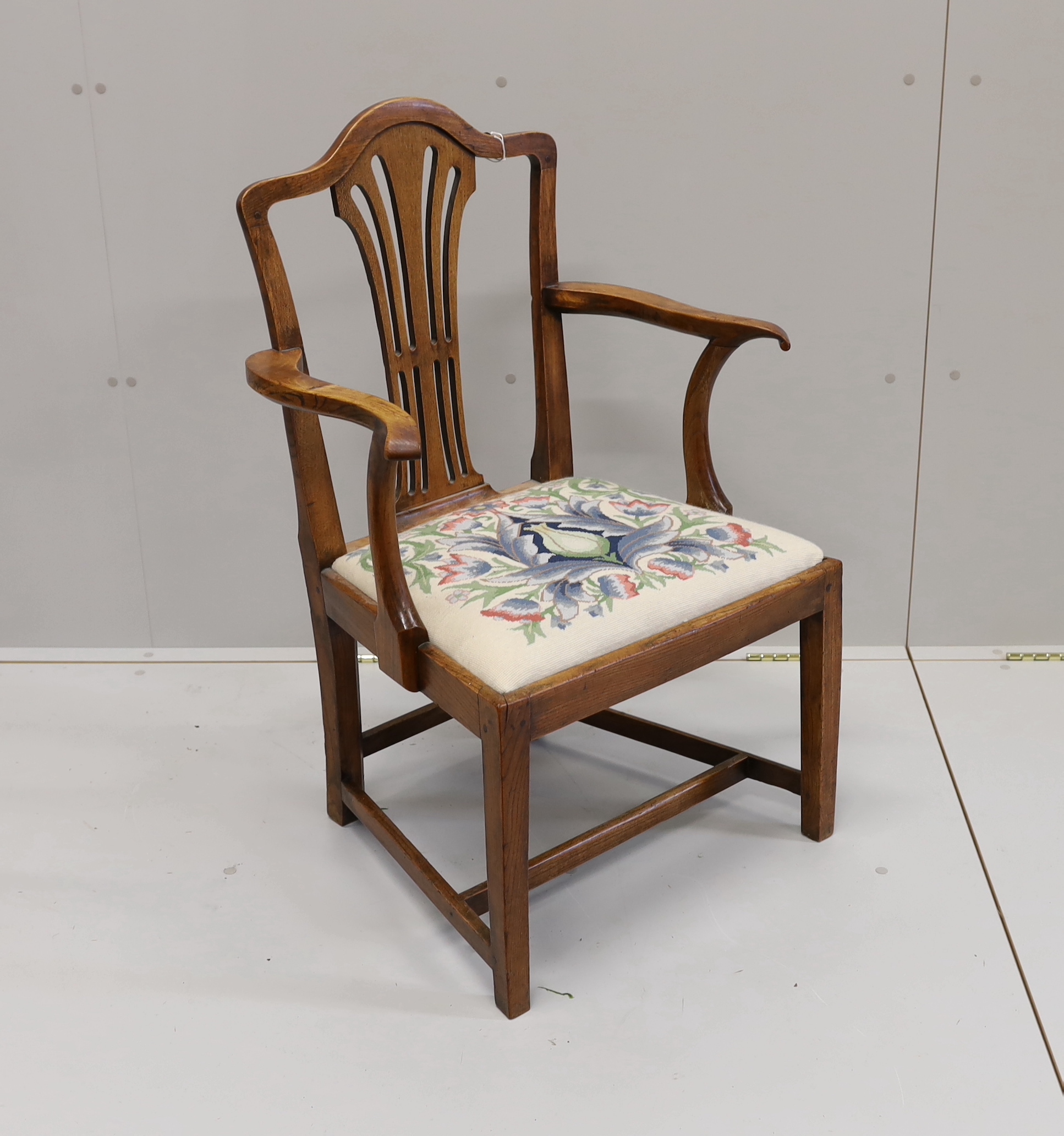 A George III provincial elm elbow chair, width 58cm, depth 45cm, height 94cm